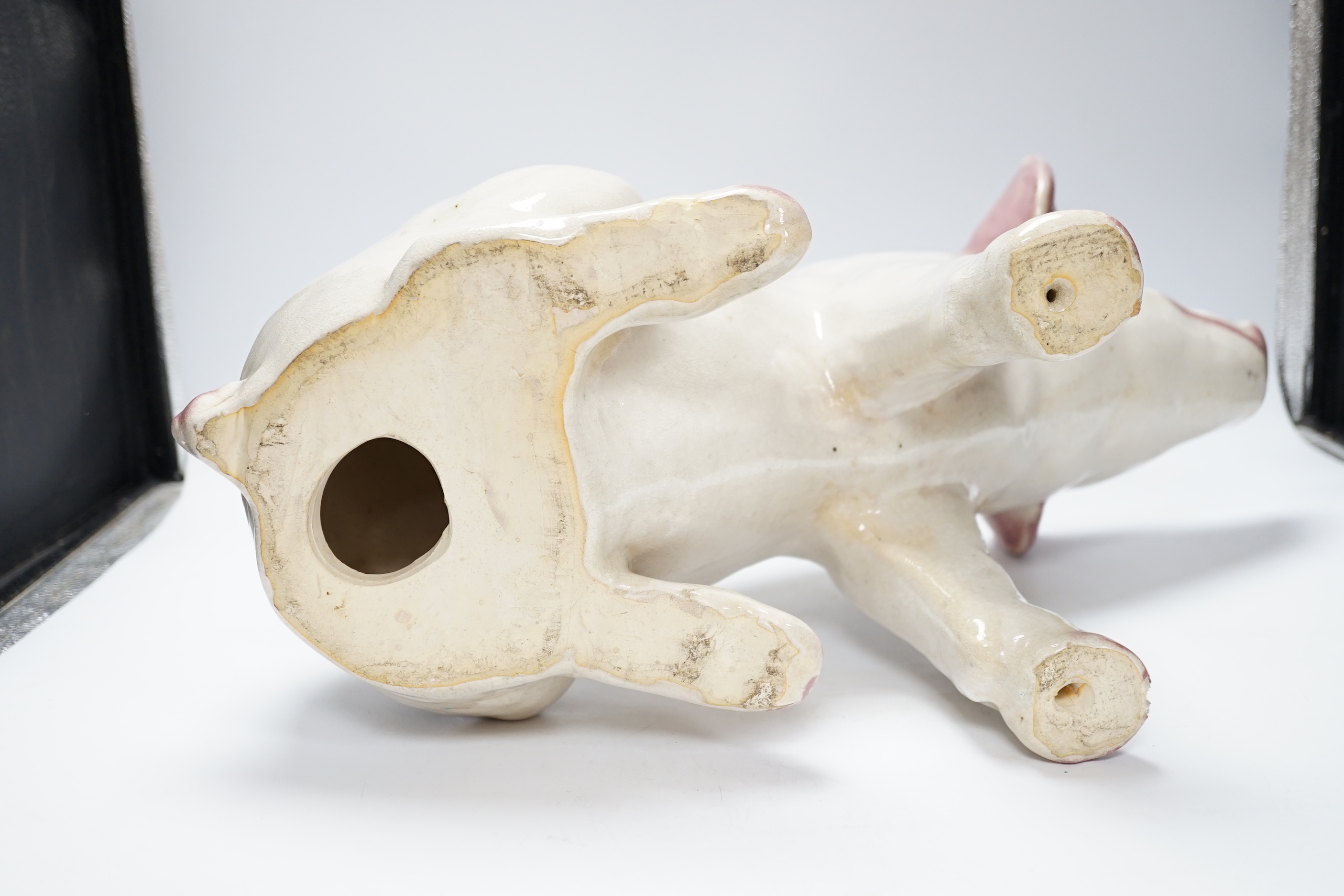 A large earthenware model of a seated piglet, 31cm high